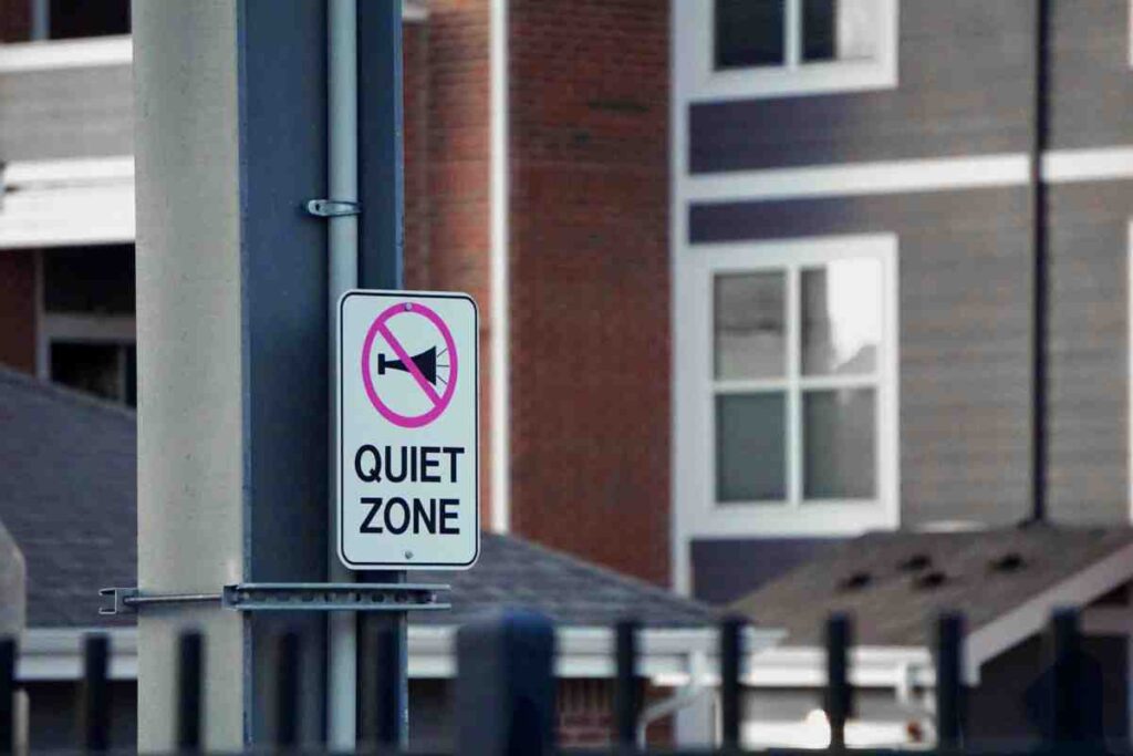 Invisible Fence HOA Rules — Quiet Zone sign posted near residential apartment buildings